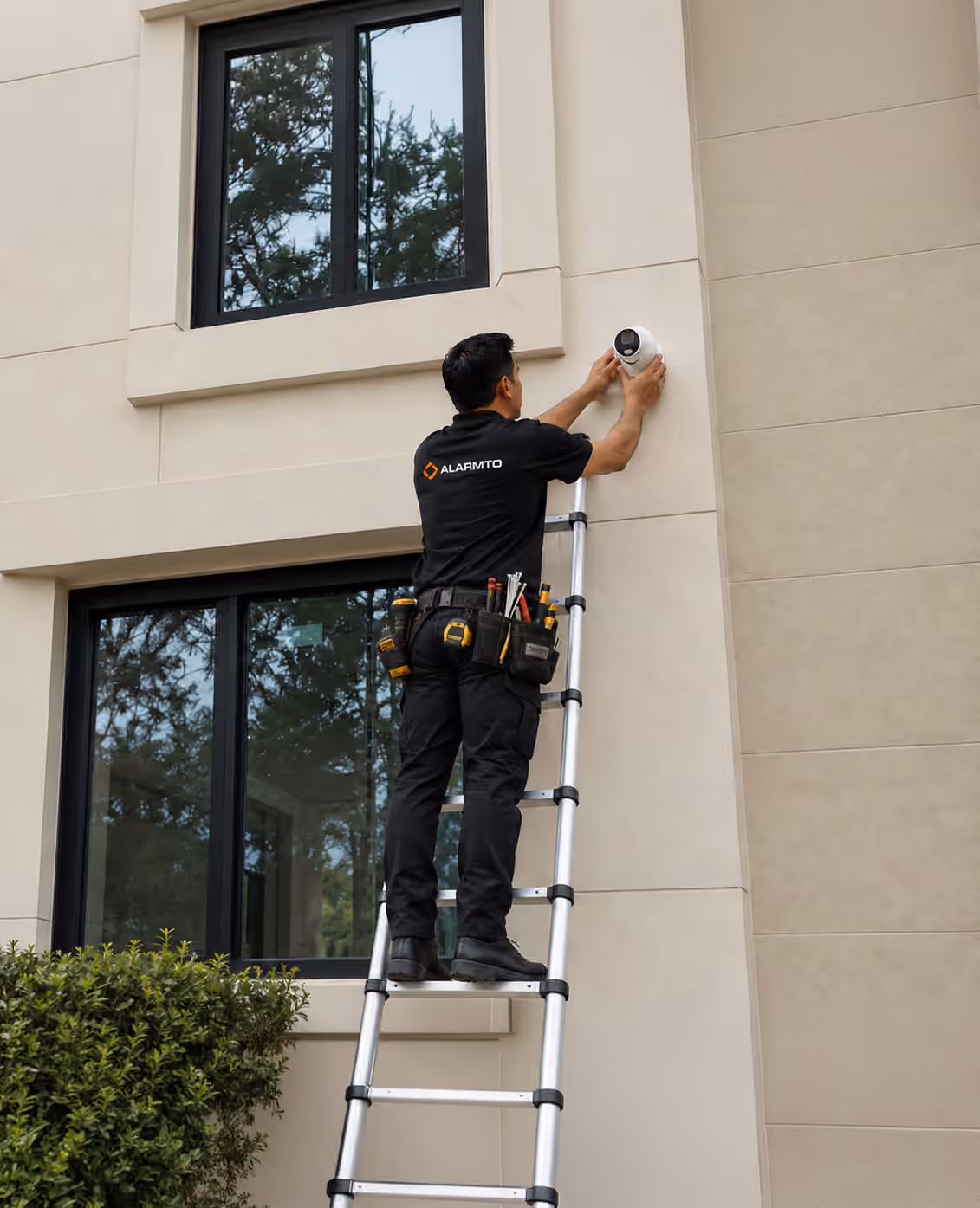 Alarmto technician installing an exterior security camera