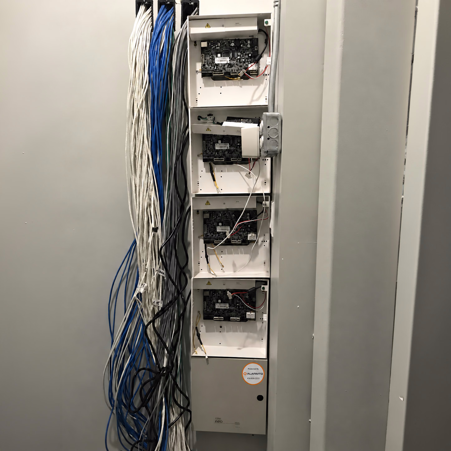 Alarmto equipment cabinet with bundled commercial network and security cabling