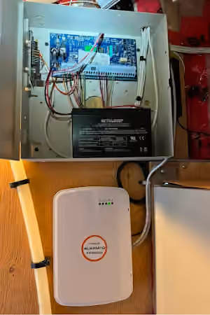 Second view of the alarm control panel, wiring, backup battery and communications unit.
