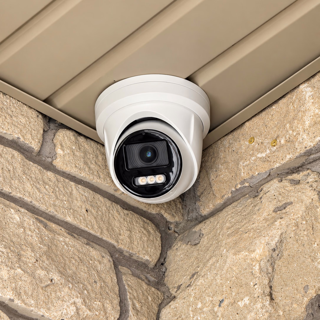 White security camera mounted beneath an exterior soffit